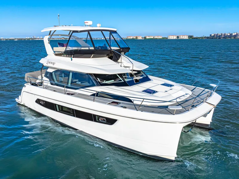 Slide: The Image of 2022 Aquila 44 Yacht cruising on open water under clear blue skies. - 10