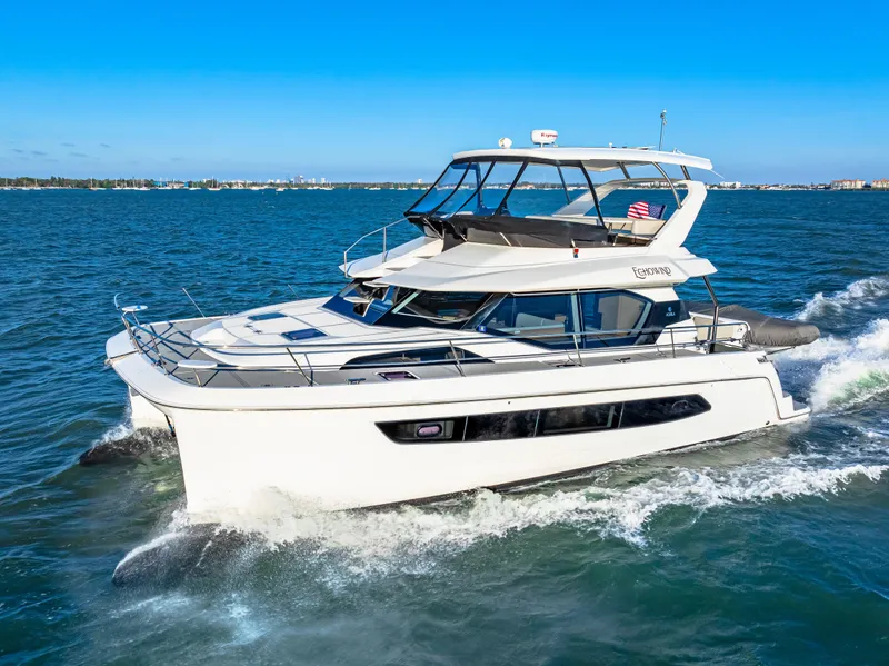 Slide: The Image of Aquila 44 Yacht 2022 cruising on open water under clear blue skies. - 14