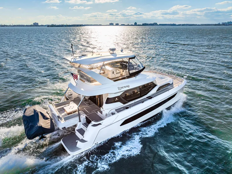 Slide: The Image of Aquila 44 Yacht 2022 cruising on open water under a clear sky. - 15