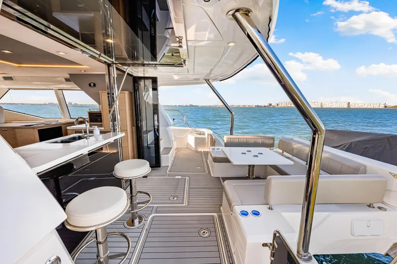 Slide: The Image of Luxurious 2022 Aquila 44 Yacht interior with modern seating and ocean view. - 17