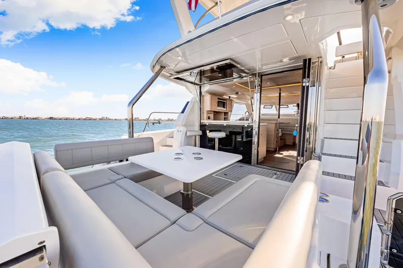 Slide: The Image of 2022 Aquila 44 Yacht interior with seating area and ocean view. - 18