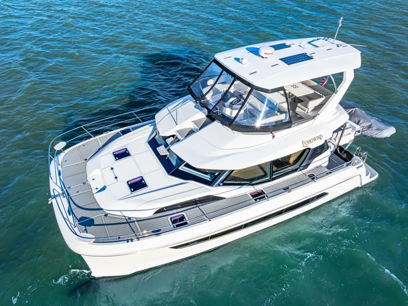 Slide: The Image of Aquila 44 Yacht 2022 cruising on clear blue water, showcasing sleek design and modern features. - 2