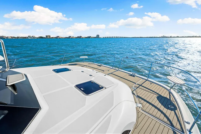 Slide: The Image of Aquila 44 Yacht 2022 cruising on open water under a clear blue sky. - 20