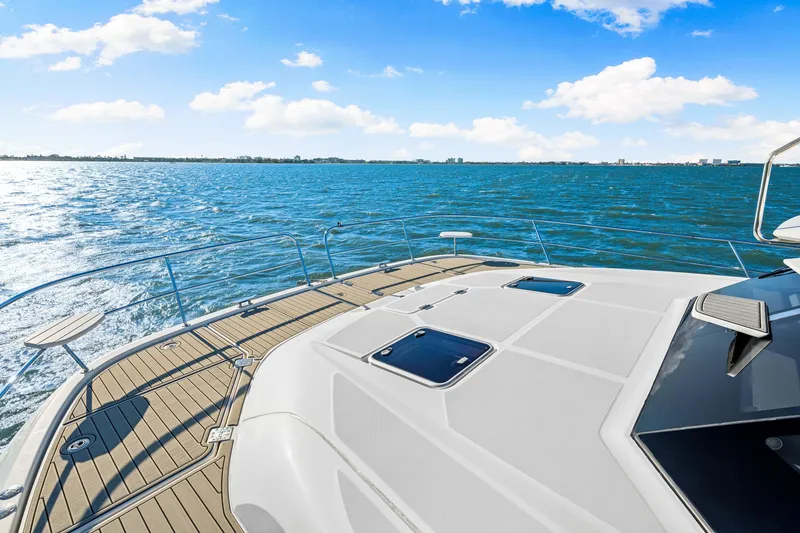 Slide: The Image of Aquila 44 Yacht 2022 on open water, sunny day, clear blue sky. - 21