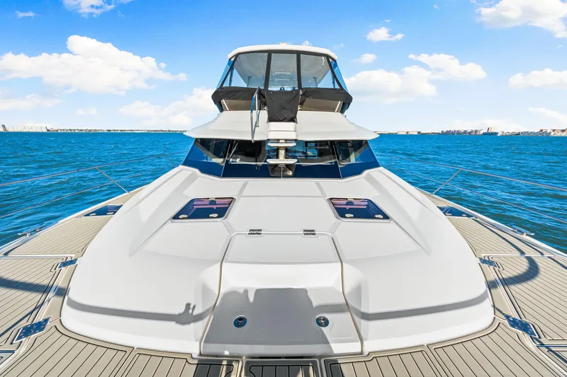 Slide: The Image of 2022 Aquila 44 Yacht on open water, showcasing sleek design and spacious deck. - 22