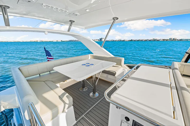 Slide: The Image of Aquila 44 Yacht 2022 interior with ocean view, featuring seating and table. - 32