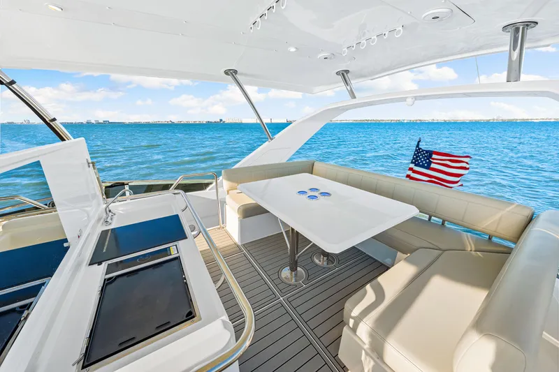 Slide: The Image of Aquila 44 Yacht 2022 interior with seating, table, and ocean view. - 33