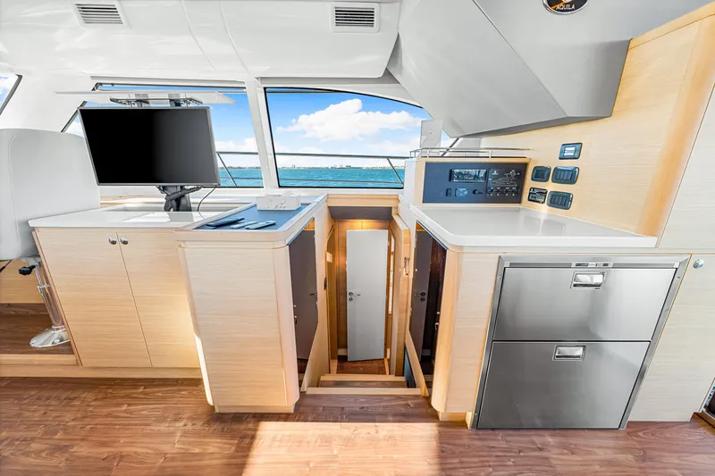 Slide: The Image of Interior of 2022 Aquila 44 Yacht with modern cabinetry and ocean view. - 43