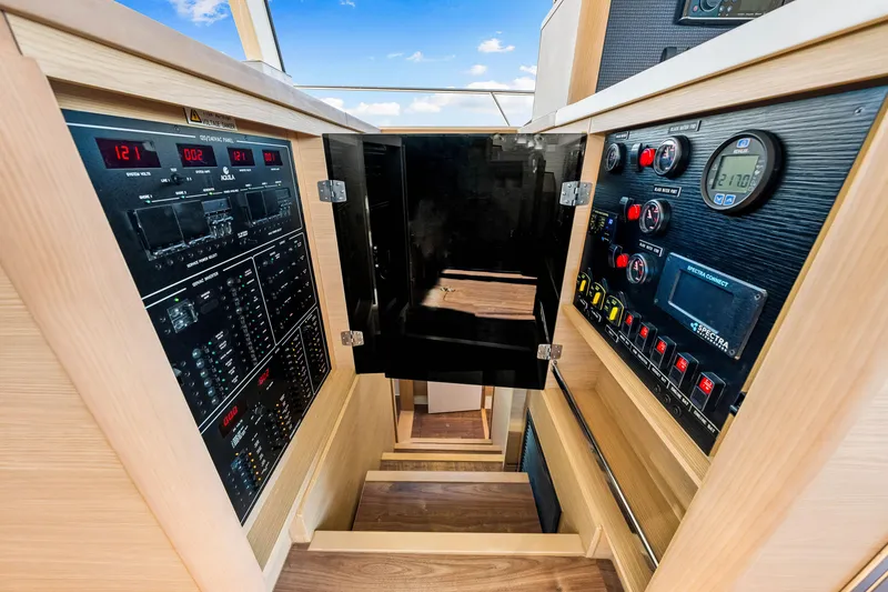 Slide: The Image of Control panel and stairs inside 2022 Aquila 44 Yacht, showcasing modern navigation equipment. - 44