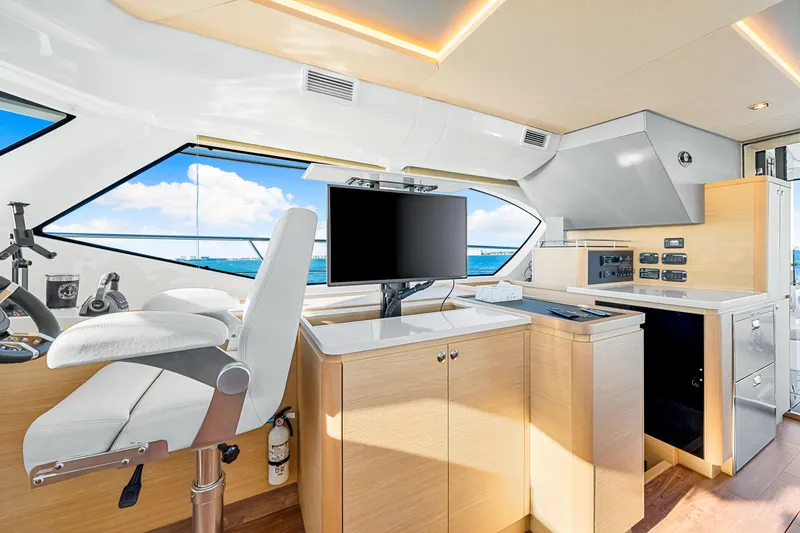 Slide: The Image of Interior of 2022 Aquila 44 Yacht, featuring modern helm station and panoramic windows. - 45