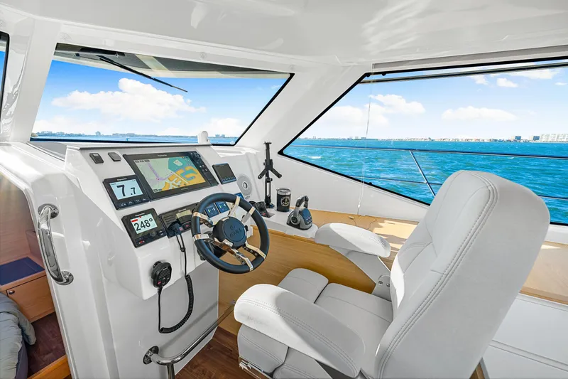 Slide: The Image of Interior helm of 2022 Aquila 44 Yacht with navigation equipment and ocean view. - 46