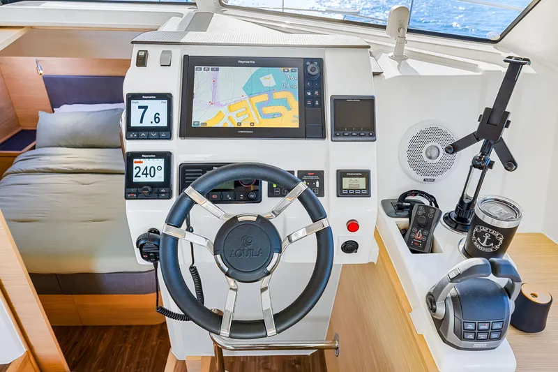 Slide: The Image of Cockpit of 2022 Aquila 44 Yacht with navigation equipment and steering wheel. - 47