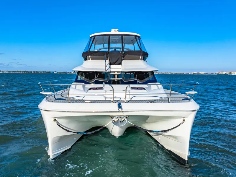 Slide: The Image of 2022 Aquila 44 Yacht cruising on open water under clear blue skies. - 5