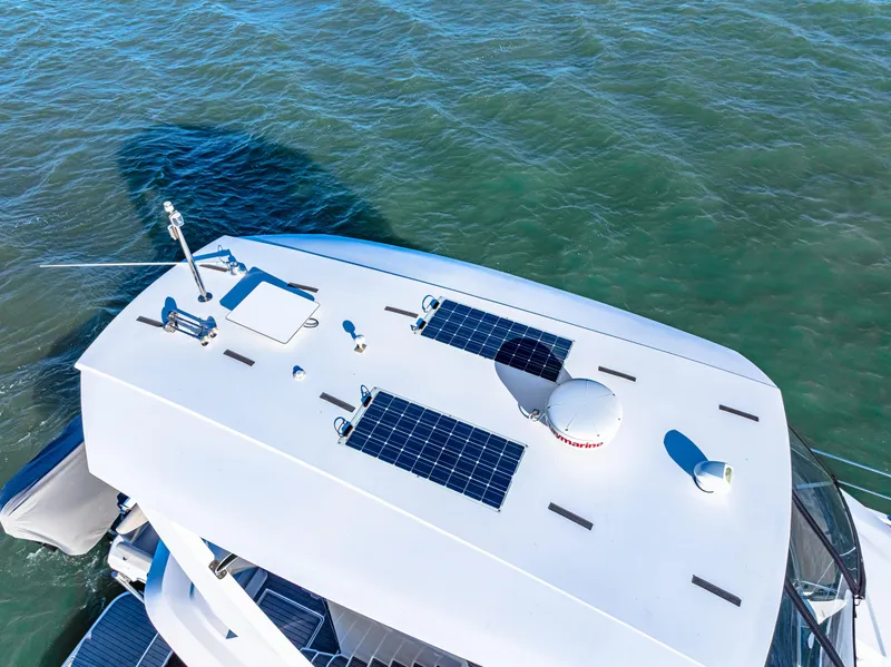 Slide: The Image of Aquila 44 Yacht 2022 with solar panels on the roof, cruising on open water. - 7