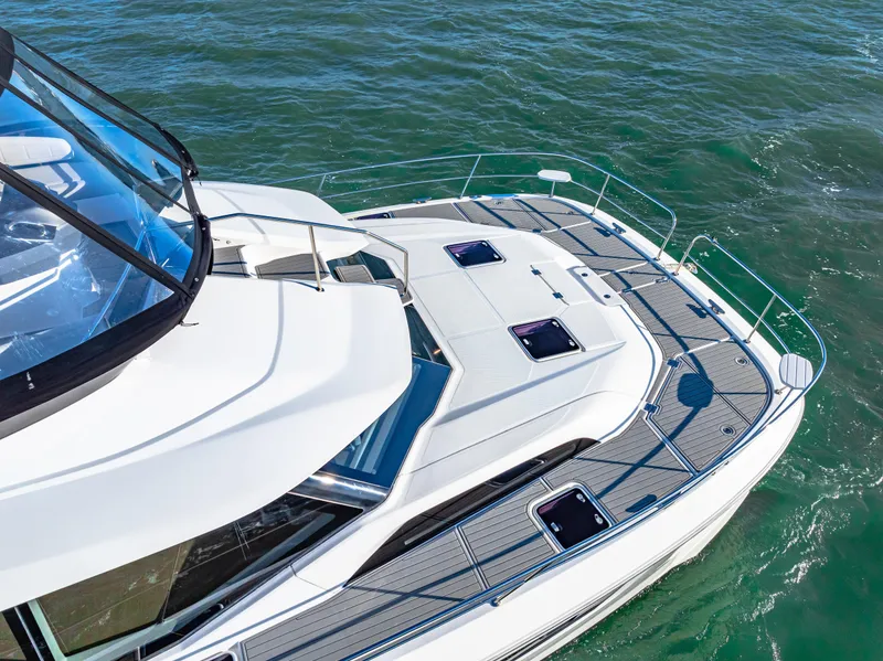 Slide: The Image of Aquila 44 Yacht 2022 cruising on clear blue waters, showcasing sleek design and spacious deck. - 9