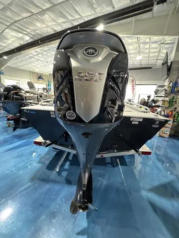 Slide: The Image of 2025 G3 Sportsman 2100 boat with powerful engine, displayed indoors on blue flooring. - 5