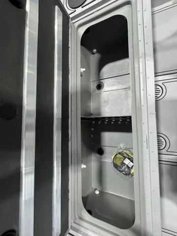 Slide: The Image of 2025 G3 Sportsman 2100 storage compartment with open lid, showcasing interior space and design. - 6