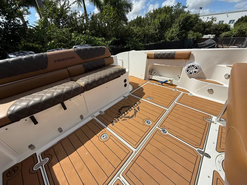 Slide: The Image of 2010 Fountain 38 LX boat interior with cushioned seating and teak-style flooring. - 12