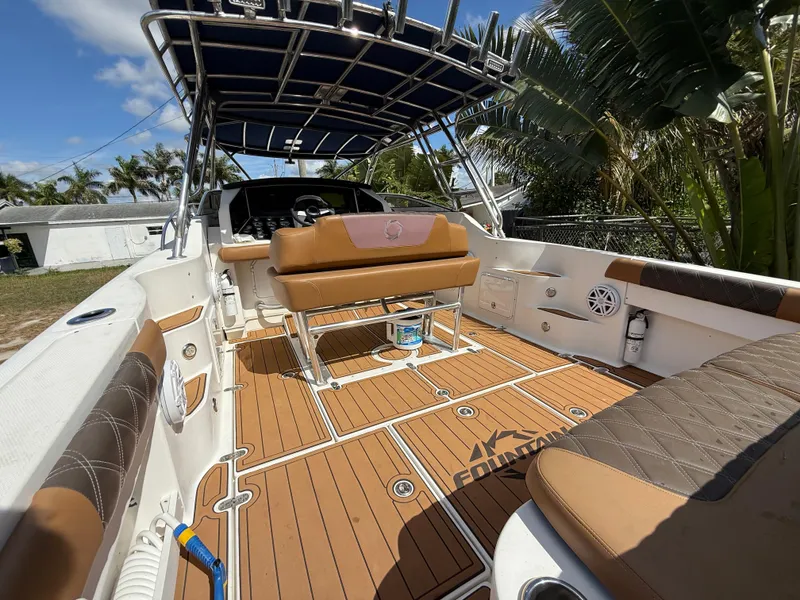 Slide: The Image of 2010 Fountain 38 LX boat interior with teak flooring and cushioned seating. - 13