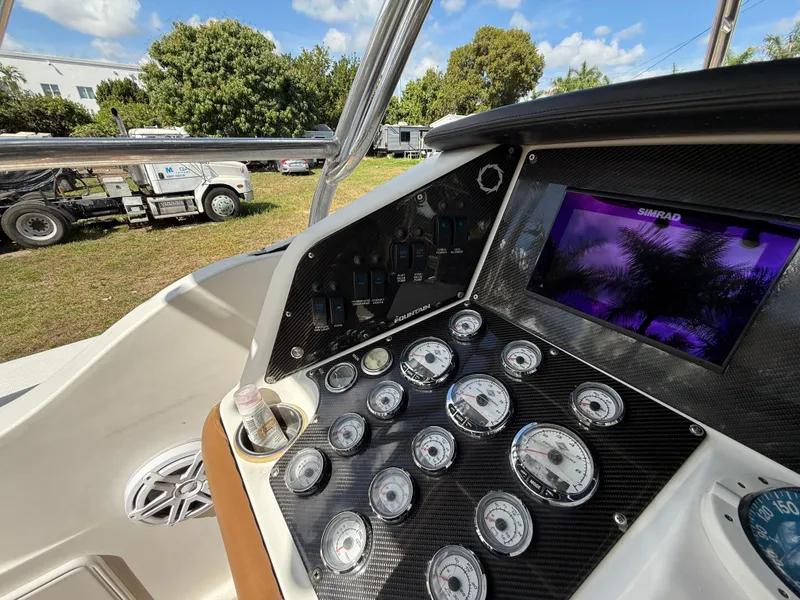 Slide: The Image of Control panel of 2010 Fountain 38 LX boat with gauges and display screen. - 22