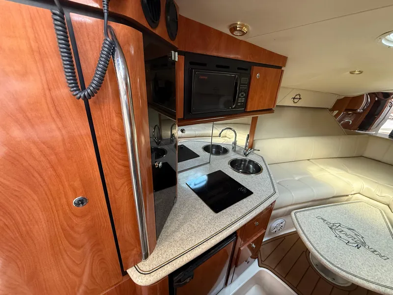 Slide: The Image of Interior of 2010 Fountain 38 LX boat with kitchenette and seating area. - 28