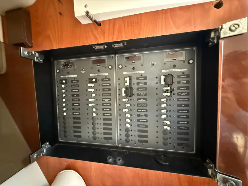 Slide: The Image of Control panel of a 2010 Fountain 38 LX boat, featuring various switches and indicators. - 34