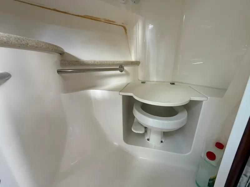 Slide: The Image of 2010 Fountain 38 LX boat bathroom with compact toilet and storage space. - 36