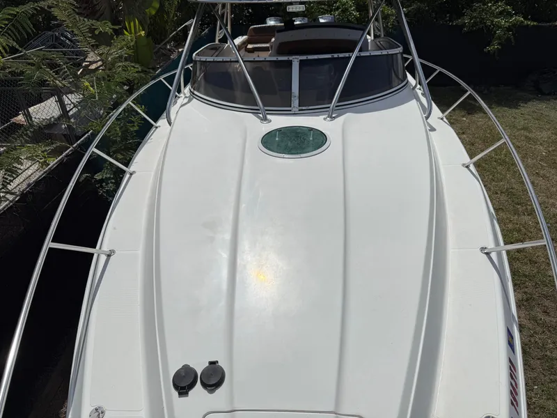 Slide: The Image of 2010 Fountain 38 LX boat with sleek white deck and stainless steel railings. - 39