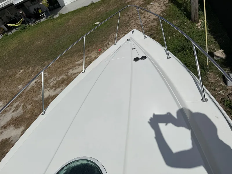 Slide: The Image of 2010 Fountain 38 LX boat deck with railing, shadow of person taking photo. - 41