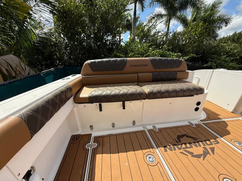 Slide: The Image of 2010 Fountain 38 LX boat interior with cushioned seating and teak flooring. - 5