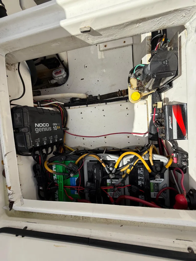 Slide: The Image of Electrical compartment of a 2010 Fountain 38 LX boat with wiring and battery charger. - 9