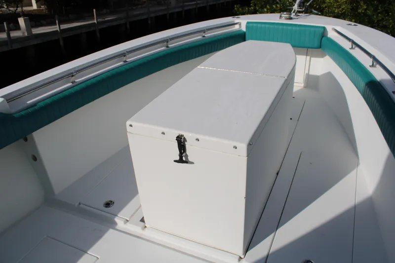 Slide: The Image of 1999 Whitewater 28 Center Console boat with teal seating and storage box. - 11