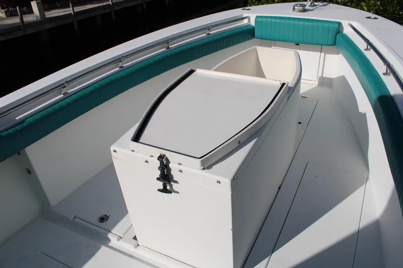 Slide: The Image of 1999 Whitewater 28 Center Console boat interior with teal seating and storage compartment. - 13