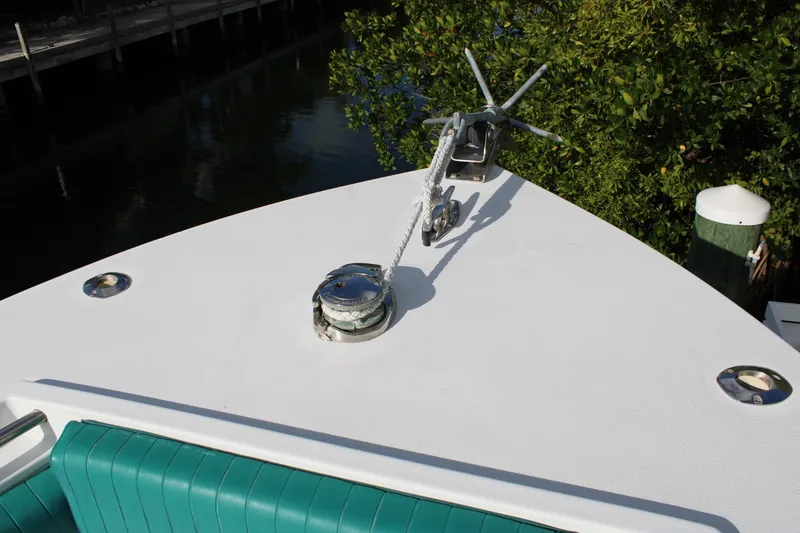 Slide: The Image of Bow of 1999 Whitewater 28 Center Console with anchor and teal seating. - 14