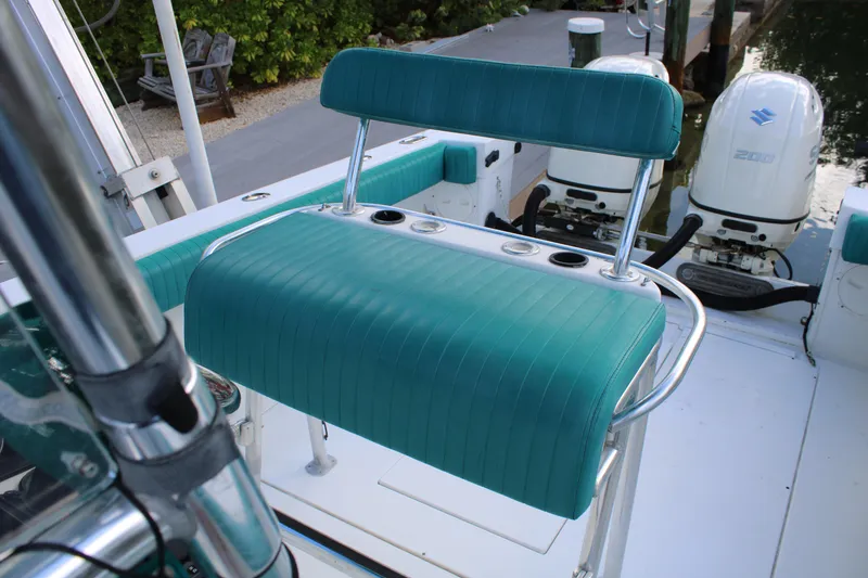Slide: The Image of 1999 Whitewater 28 Center Console boat with teal seating and dual outboard motors. - 15