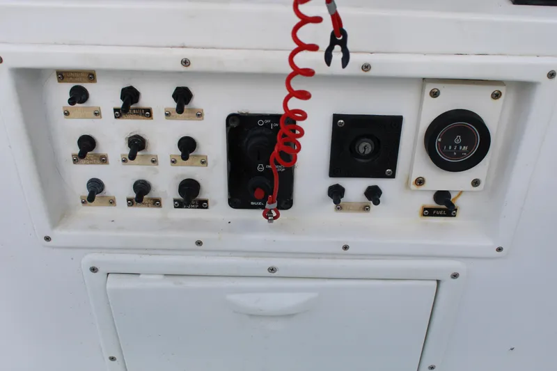 Slide: The Image of Control panel of a 1999 Whitewater 28 Center Console boat with switches and gauges. - 21