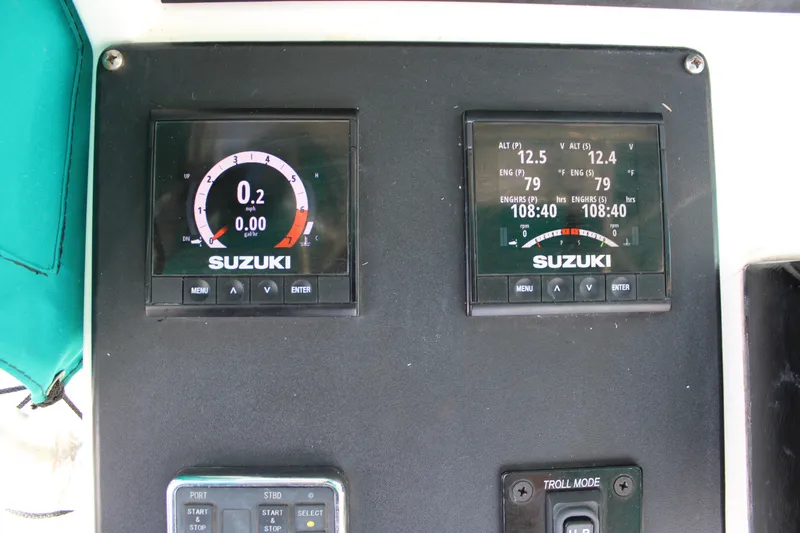 Slide: The Image of Suzuki marine gauges on 1999 Whitewater 28 Center Console boat dashboard. - 23
