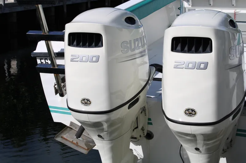 Slide: The Image of Twin Suzuki 200 outboard motors on a 1999 Whitewater 28 Center Console boat. - 25