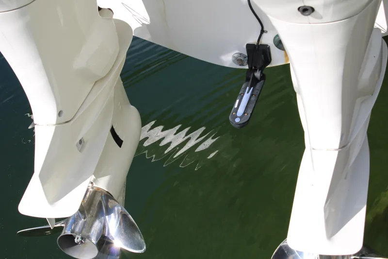 Slide: The Image of Twin outboard motors on a 1999 Whitewater 28 Center Console boat, reflecting in water. - 26