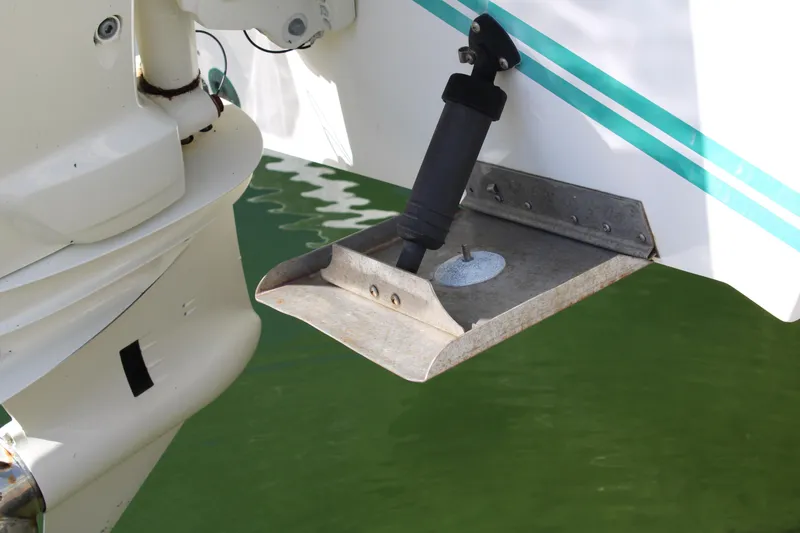 Slide: The Image of Close-up of a 1999 Whitewater 28 Center Console boat's trim tab in water. - 27