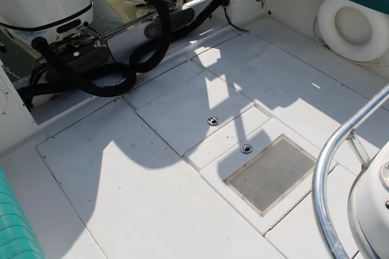 Slide: The Image of 1999 Whitewater 28 Center Console boat deck with storage compartments and railing. - 28