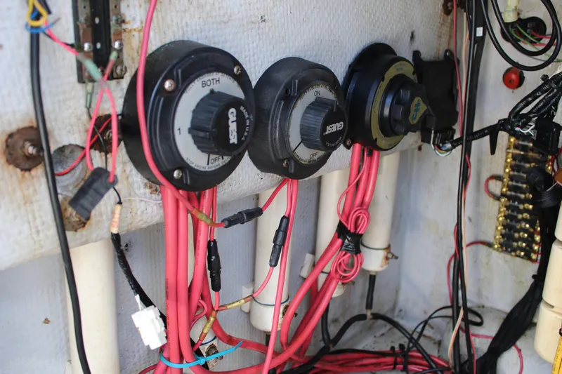 Slide: The Image of Electrical wiring and switches inside a 1999 Whitewater 28 Center Console boat. - 32