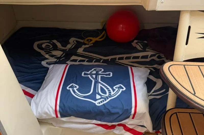 Slide: The Image of Cozy cabin interior of 2005 Hydra-Sports Vector 3300 VX with nautical-themed bedding. - 17