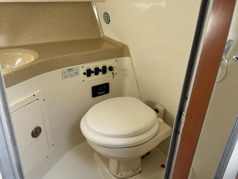 Slide: The Image of 2005 Hydra-Sports Vector 3300 VX boat bathroom with toilet and control panel. - 19