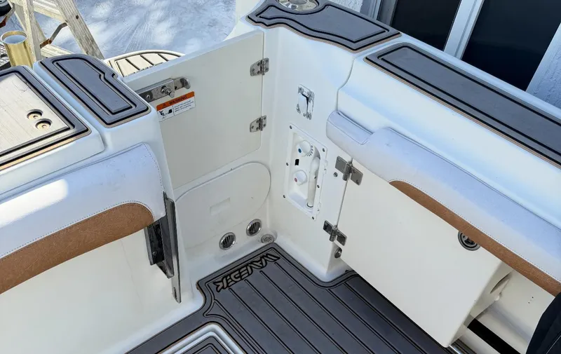 Slide: The Image of 2005 Hydra-Sports Vector 3300 VX boat interior with open storage compartments. - 4