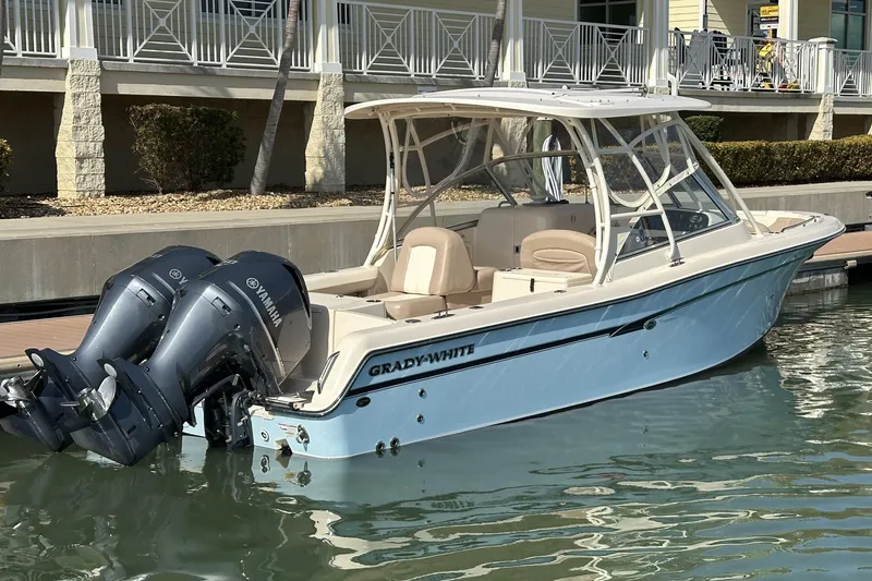 Slide: The Image of 2013 Grady-White Freedom 285 boat docked with twin outboard engines. - 1