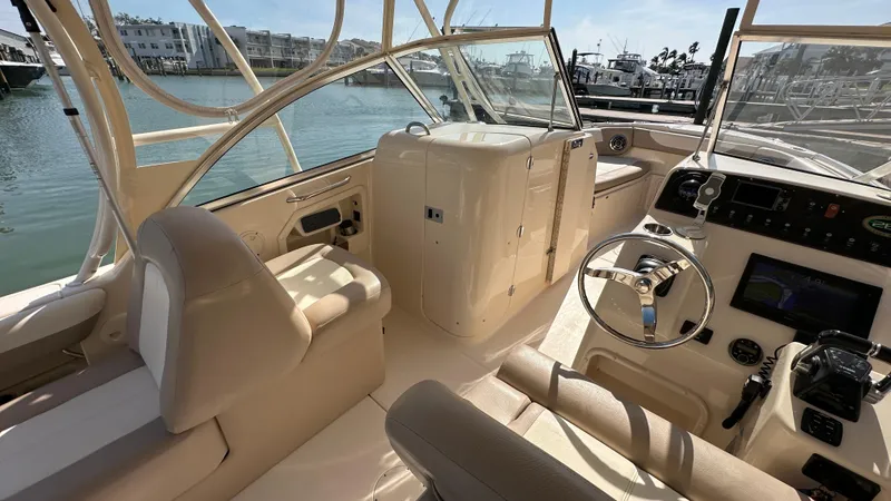 Slide: The Image of Interior view of 2013 Grady-White Freedom 285 boat, featuring helm and seating area. - 11
