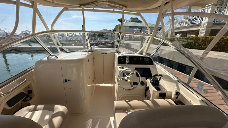 Slide: The Image of 2013 Grady-White Freedom 285 boat interior with helm, steering wheel, and seating. - 12