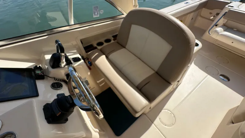 Slide: The Image of 2013 Grady-White Freedom 285 boat cockpit with steering wheel and seating. - 15