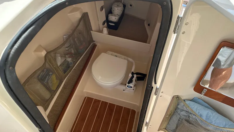 Slide: The Image of 2013 Grady-White Freedom 285 boat interior with toilet and storage compartments. - 21
